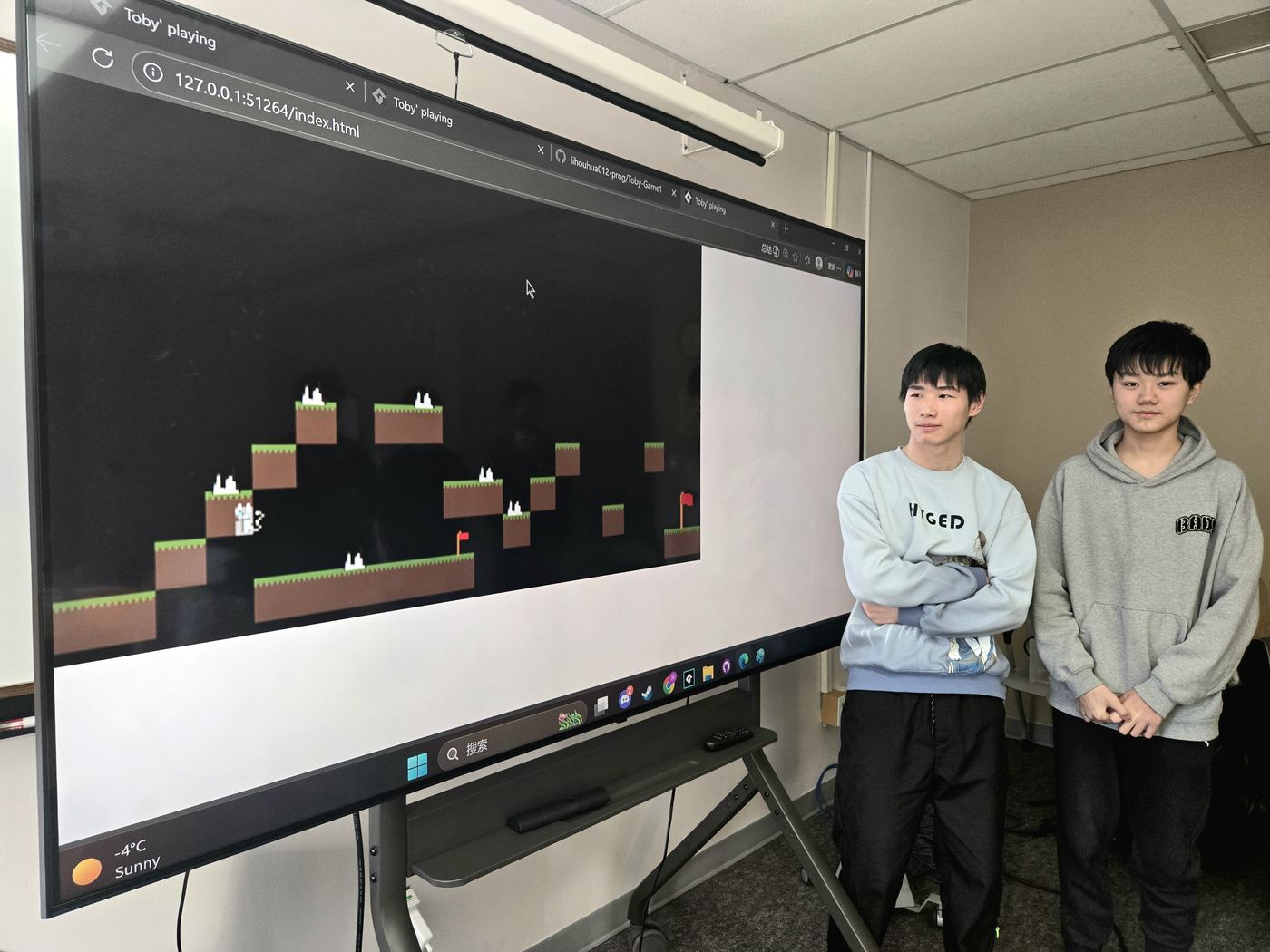 Students presenting a pixel-art game project